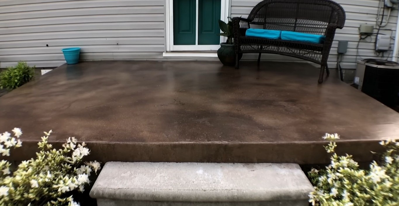 Decorative stained concrete patio with outdoor furniture